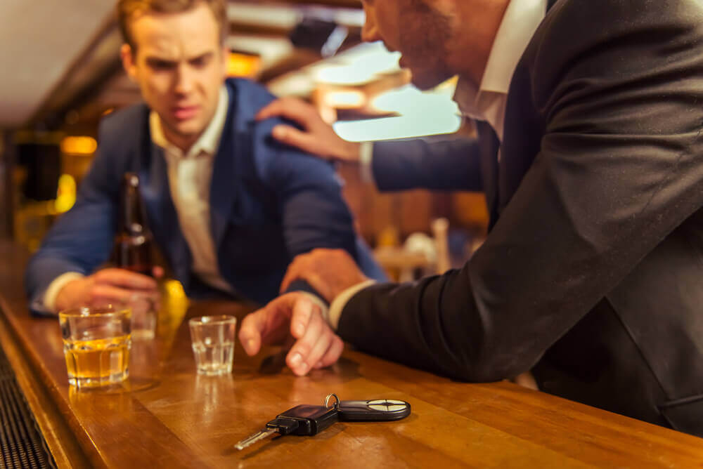 Drunk businessman reaching for his car keys.