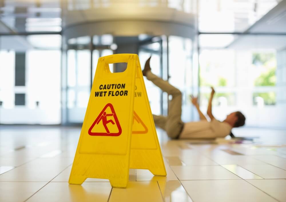 Employee falling from slippery floor.