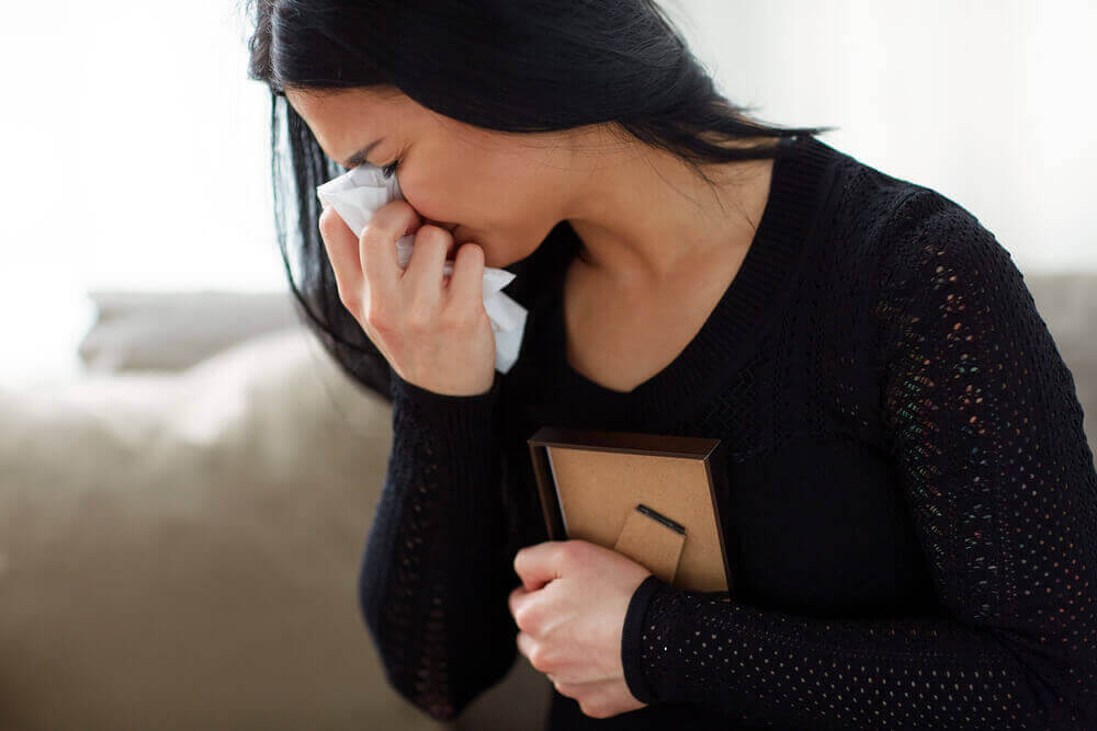 Woman crying on the loss of her late husband.